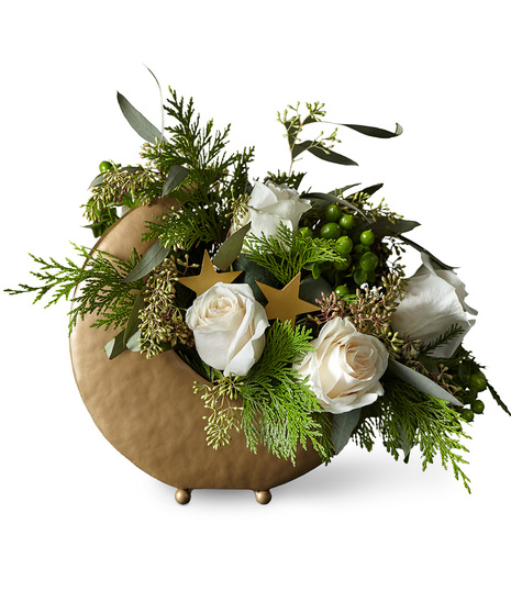 Holiday flowers arranged in metal moon vase