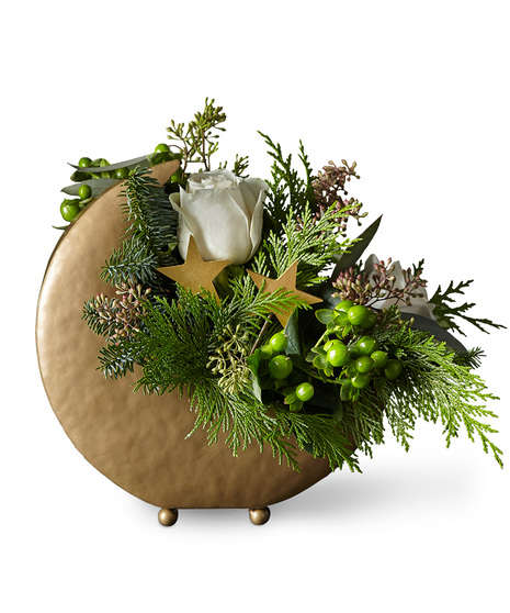 Holiday flowers arranged in metal moon vase
