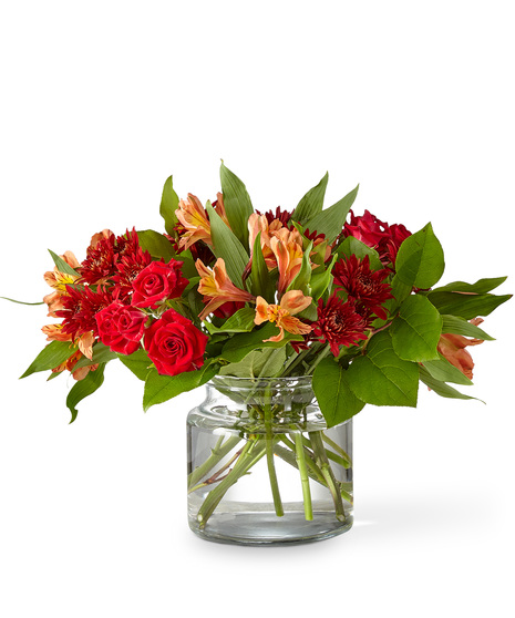 Sunset Hued Flowers Arranged in a Glass Vase
