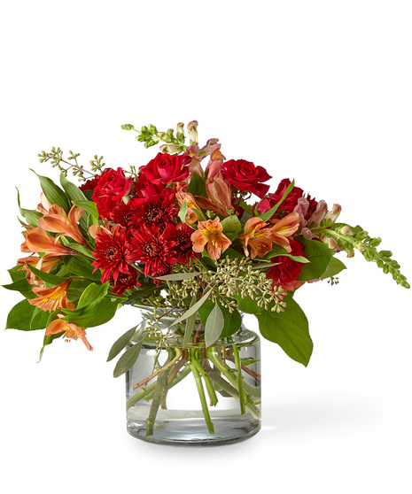 Sunset Hued Flowers Arranged in a Glass Vase