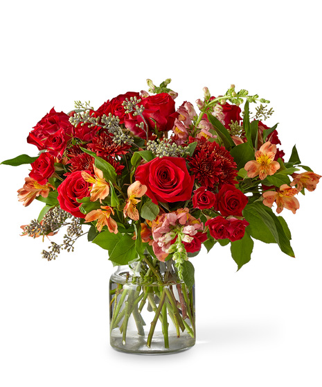 Sunset Hued Flowers Arranged in a Glass Vase