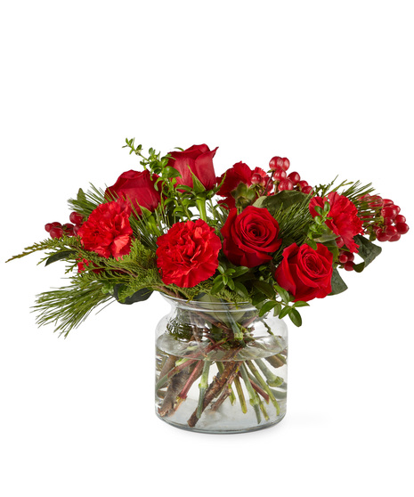 Red holiday flowers in designer vase