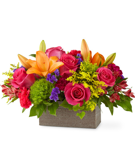 Colourful flowers arranged in a wooded rectangular box