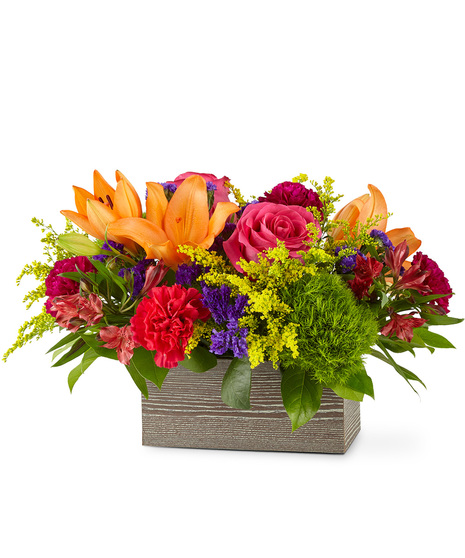 Colourful flowers arranged in a wooded rectangular box