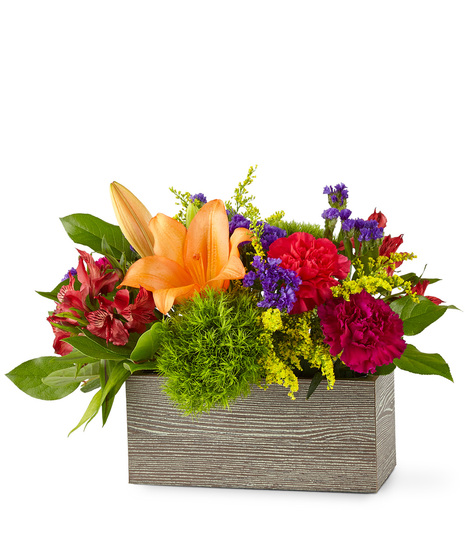 Colourful flowers arranged in a wooded rectangular box