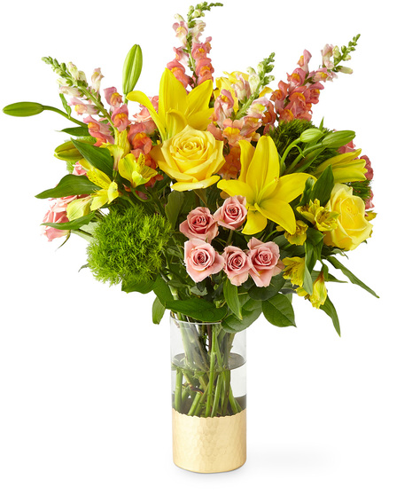 Yellow and peach flowers in a gold dipped tall glass vase