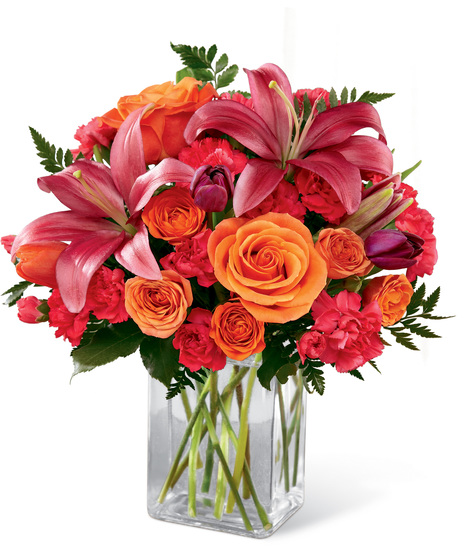 Bold colour flowers in a flat sided glass vase