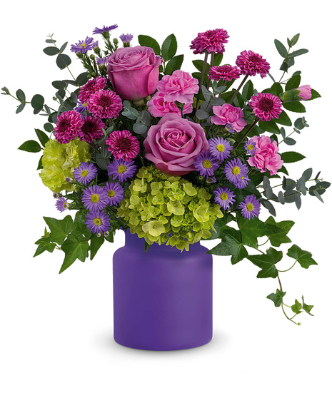 Colourful flowers in a purple frosted vase