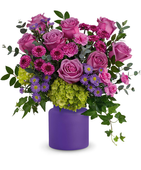 Colourful flowers in a purple frosted vase