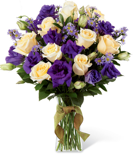 Cream and purple flowers in a glass vase