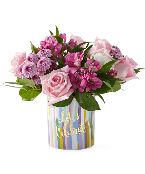 Birthday flowers in a vase that says Lets Celebrate