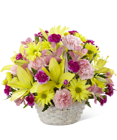 A handled basket of yellow and pink flowers