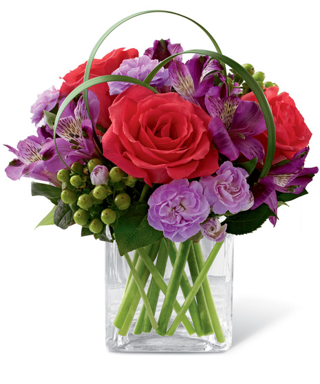 Roses, alstroemeria and carnations in a cube vase