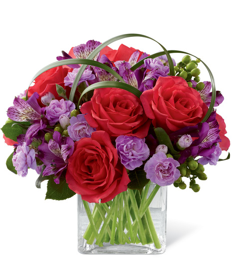 Roses, alstroemeria and carnations in a cube vase