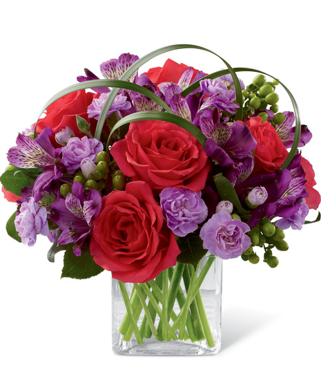 Roses, alstroemeria and carnations in a cube vase