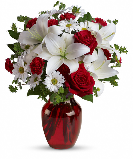 Red and white flowers in a red glass vase
