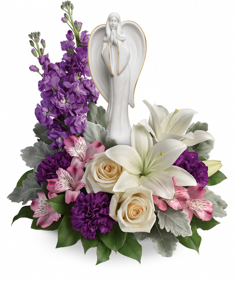 Lovely sympathy flowers with graceful scupture