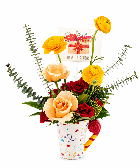 birthday flower arrangement in mug with red roses peach roses yellow ranunculus and handwritten birthday card