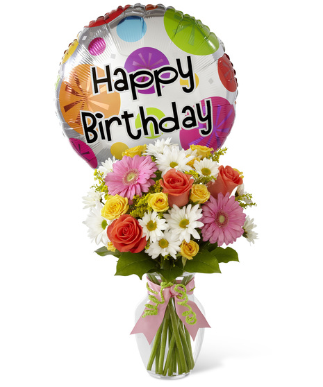 Mixed flowers in a vase with birthday balloon