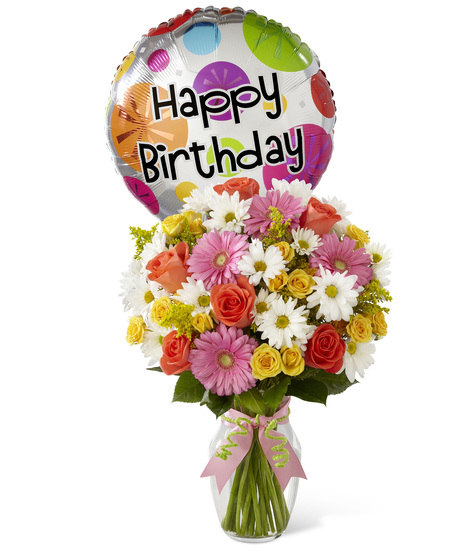 Mixed flowers in a vase with birthday balloon