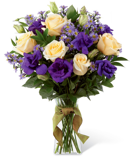 Cream and purple flowers in a glass vase