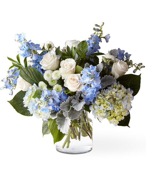 White and blue flowers in a glass vase