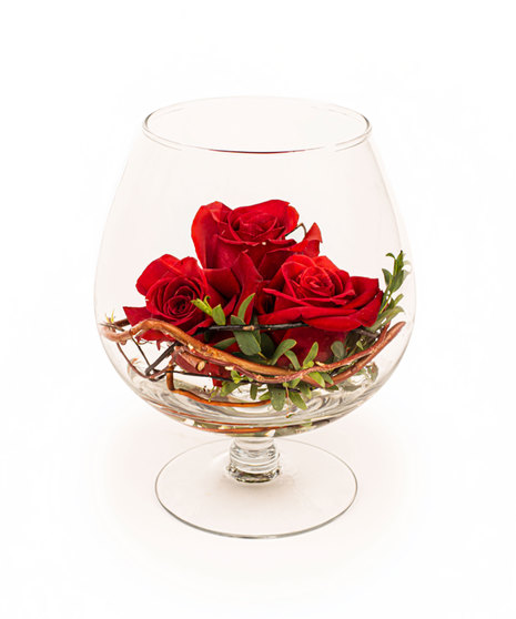 Red rose floral arrangement in a snifter glass with vine and greenery, available with one, two, or three roses.