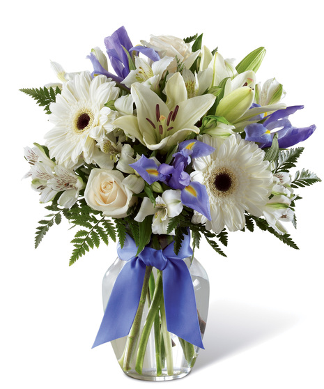 White and Purple Flowers in a Glass Vase With Bow