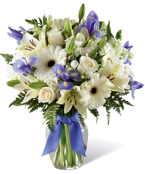 White and Purple Flowers in a Glass Vase With Bow