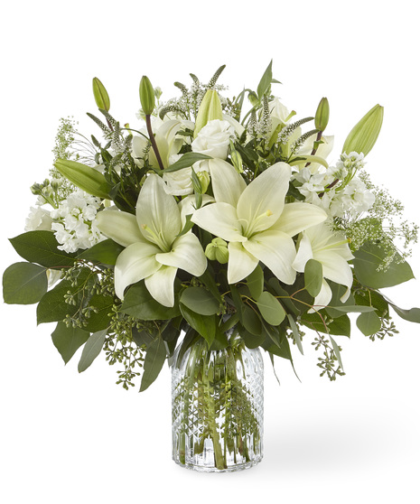 White Sympathy Flowers in a Clear Glass Vase
