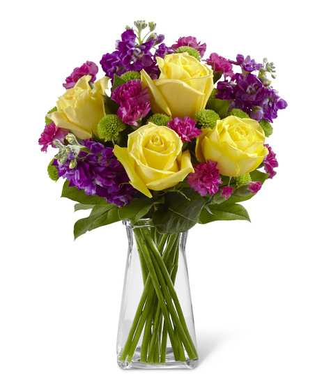 Yellow Roses With Pink and Purple Flowers in a glass vase