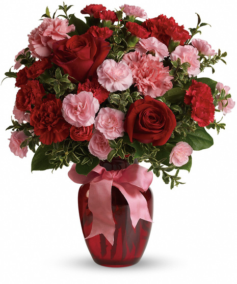 Red and pink flowers in a red glass vase