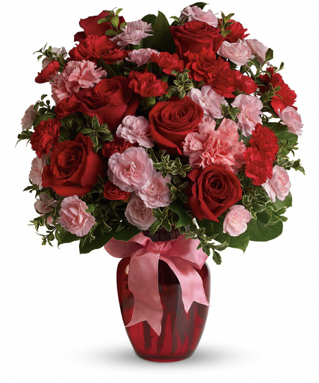 Red and pink flowers in a red glass vase