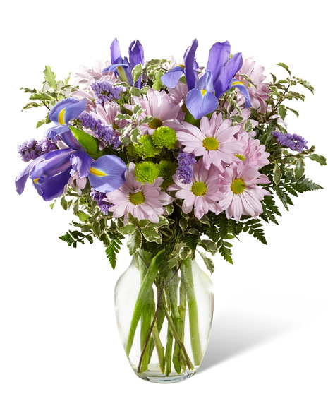 Irises and daisies in a glass vase