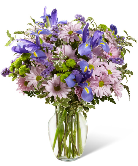 Irises and daisies in a glass vase