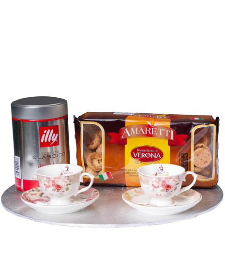 Biscotti, espresso and cups and saucers with rose pattern