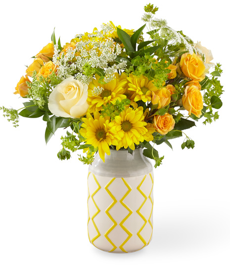 Yellow, White and Peach Flowers in a Yellow and Grey Patterned Vase