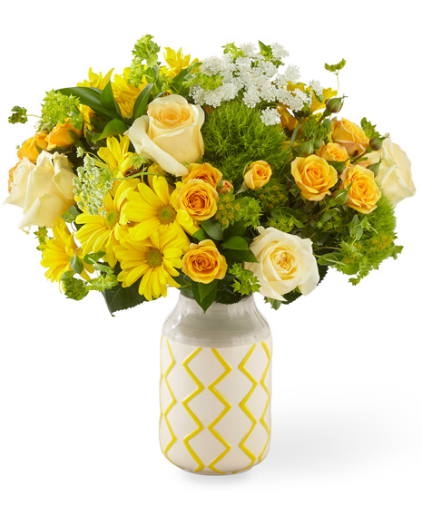 Yellow, White and Peach Flowers in a Yellow and Grey Patterned Vase