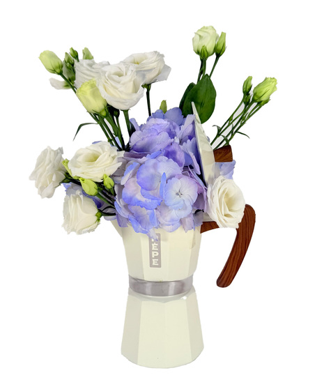 Blue hydrangea ans white lisianthus arranged in a large white Pepe mocha coffee pot - an elegant Mother's Day or all-occasion floral gift.