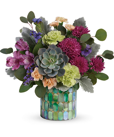 Lovely flowers arranged in a mosaic cylinder vase
