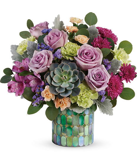Lovely flowers arranged in a mosaic cylinder vase