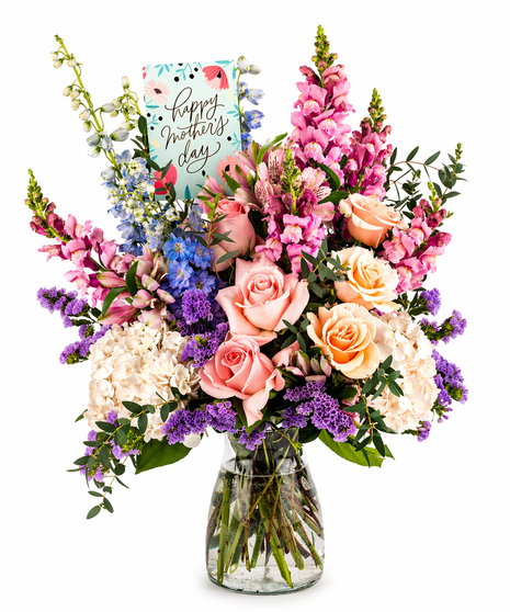 mom's day bouquet with hydrangea roses delphinium snapdragons and statice in glass vase with mother's day card