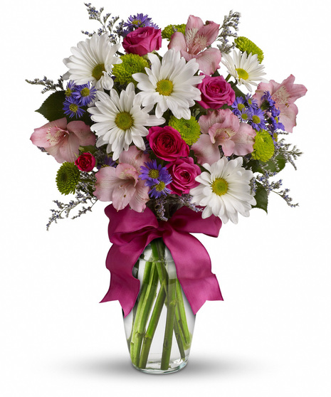 Mixed flowers in a glass vase with ribbon