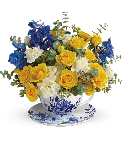 Roses and delphinium in a teacup and saucer bouquet