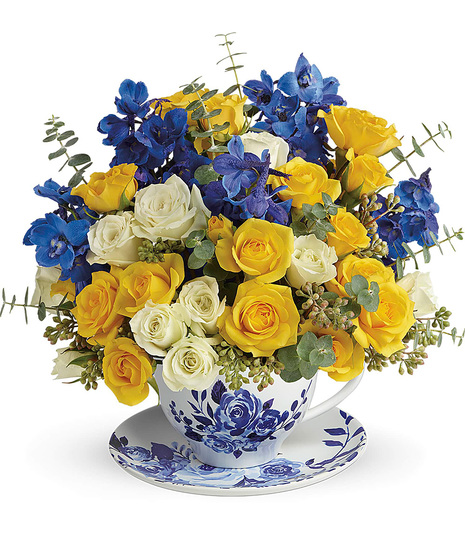 Roses and delphinium in a teacup and saucer bouquet