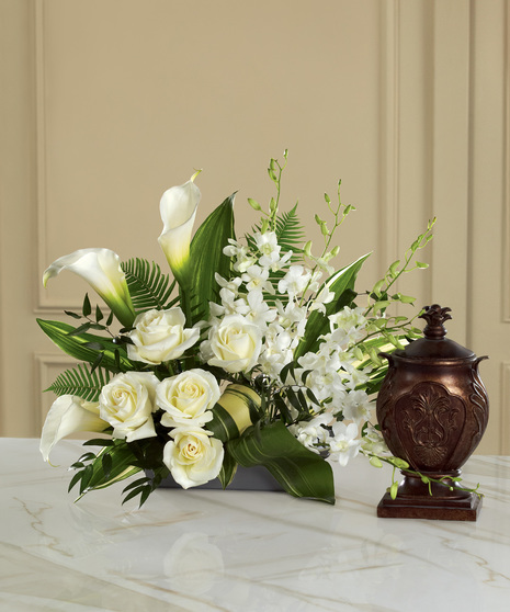 White flower arrangement for display with an urn