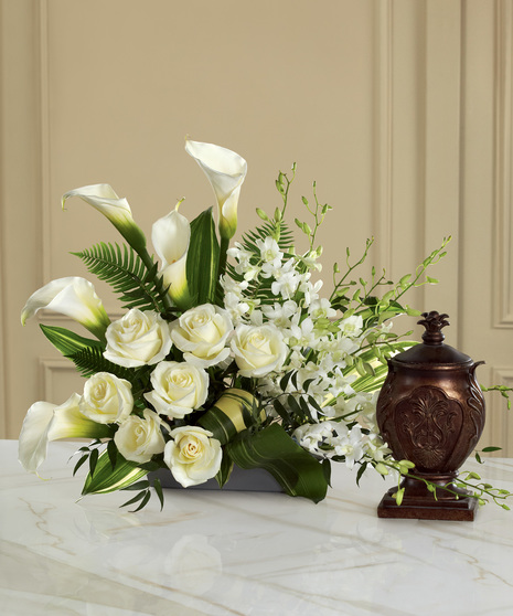 White flower arrangement for display with an urn