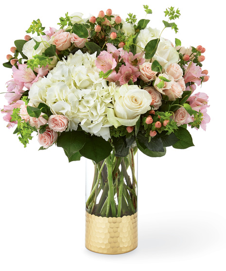 Hydrangea and rose bouquet in a designer glass vase