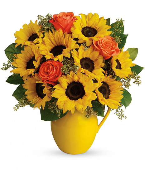 Sunflowers in a yellow ceramic pitcher