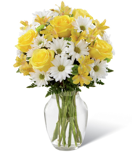 Yellow and white flowers in a glass vase